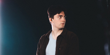 Owen Moriarty performing at Tramlines Festival as part of Hannah Rowe's band - looking to one side