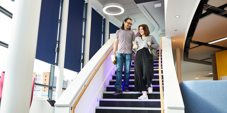 Library Female And Male Student Stairs