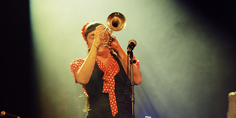 Olivia Cuttill playing trumpet on stage